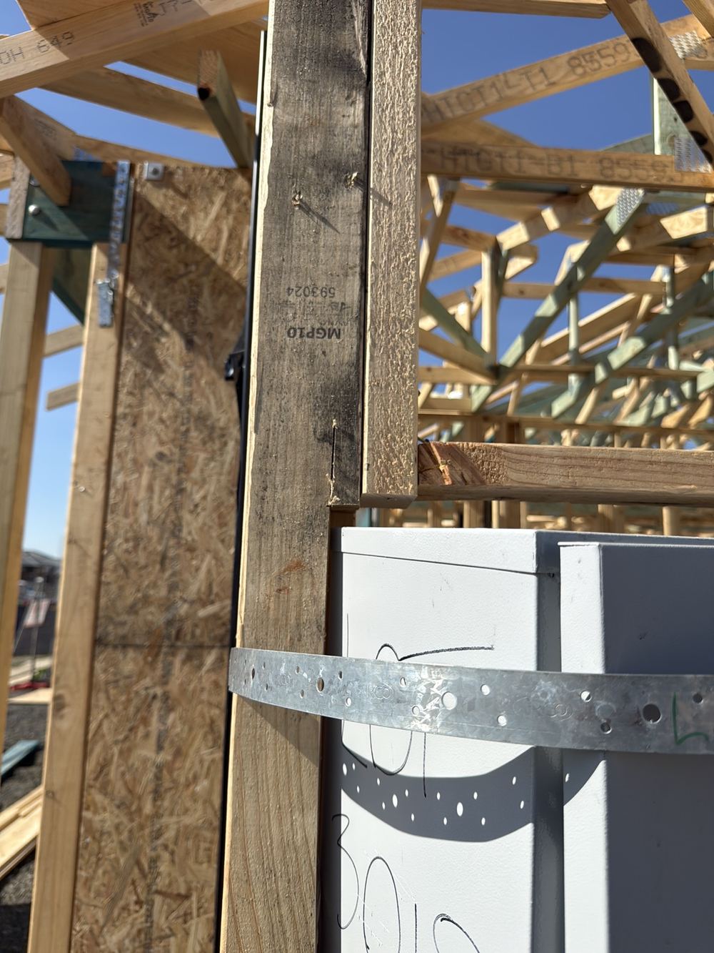 Studs cut away for the meter box, leaving the wall corner unsupported, found during a frame inspection in Clyde North