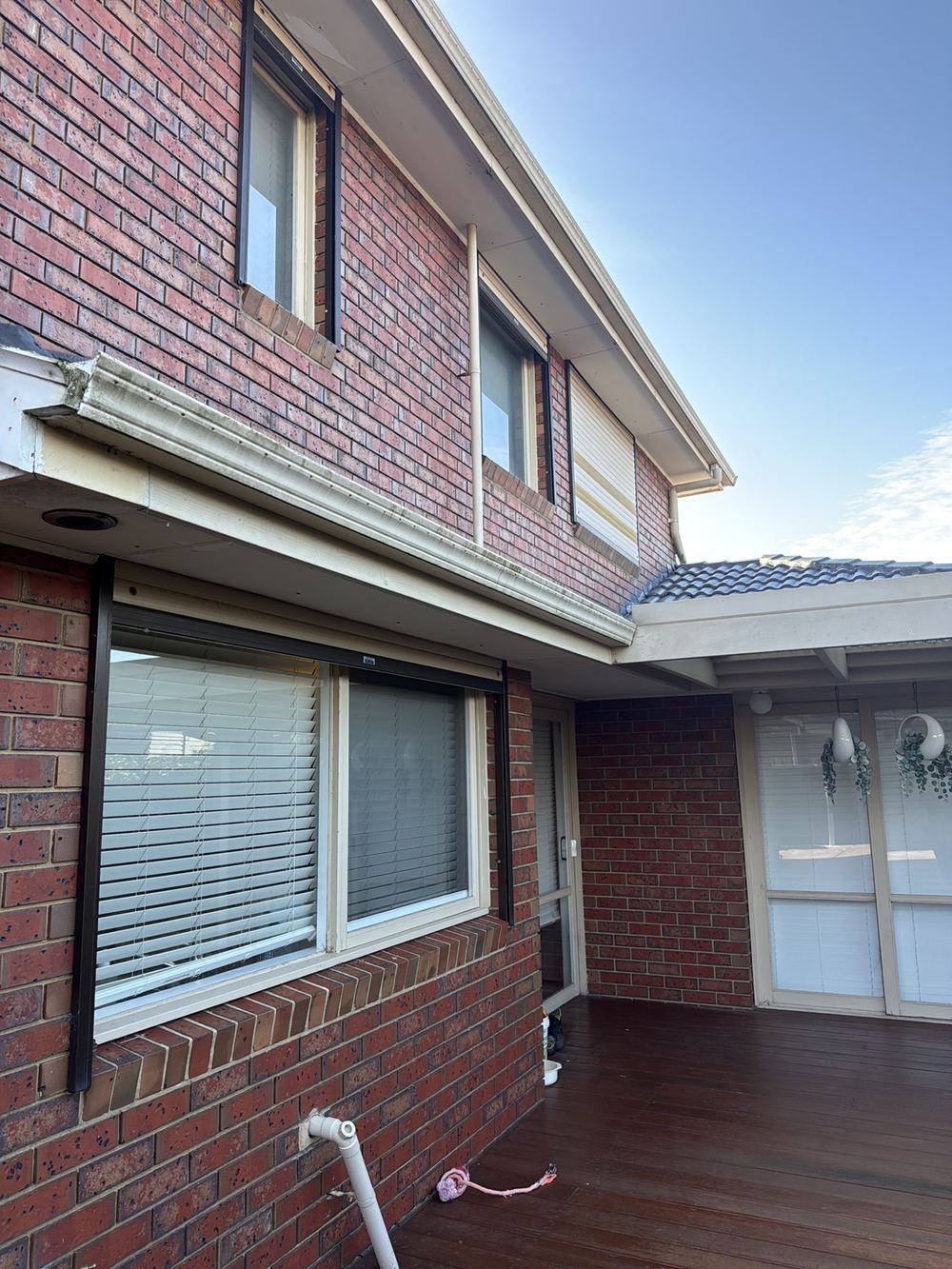 Gutter without enough fall to its downpipe, so water ponds and spills, found during a defect investigation inspection in Aspendale Gardens