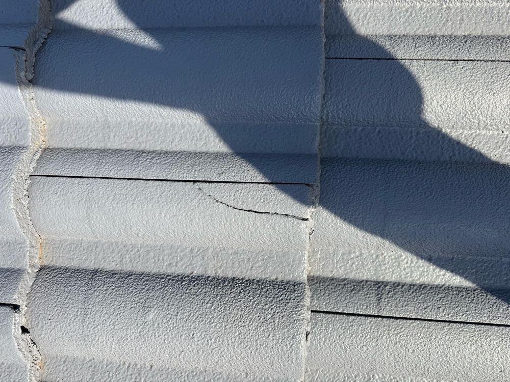 Chipped roof tiles patched with a repair that will not keep water out, found during a defect investigation inspection in Aspendale Gardens