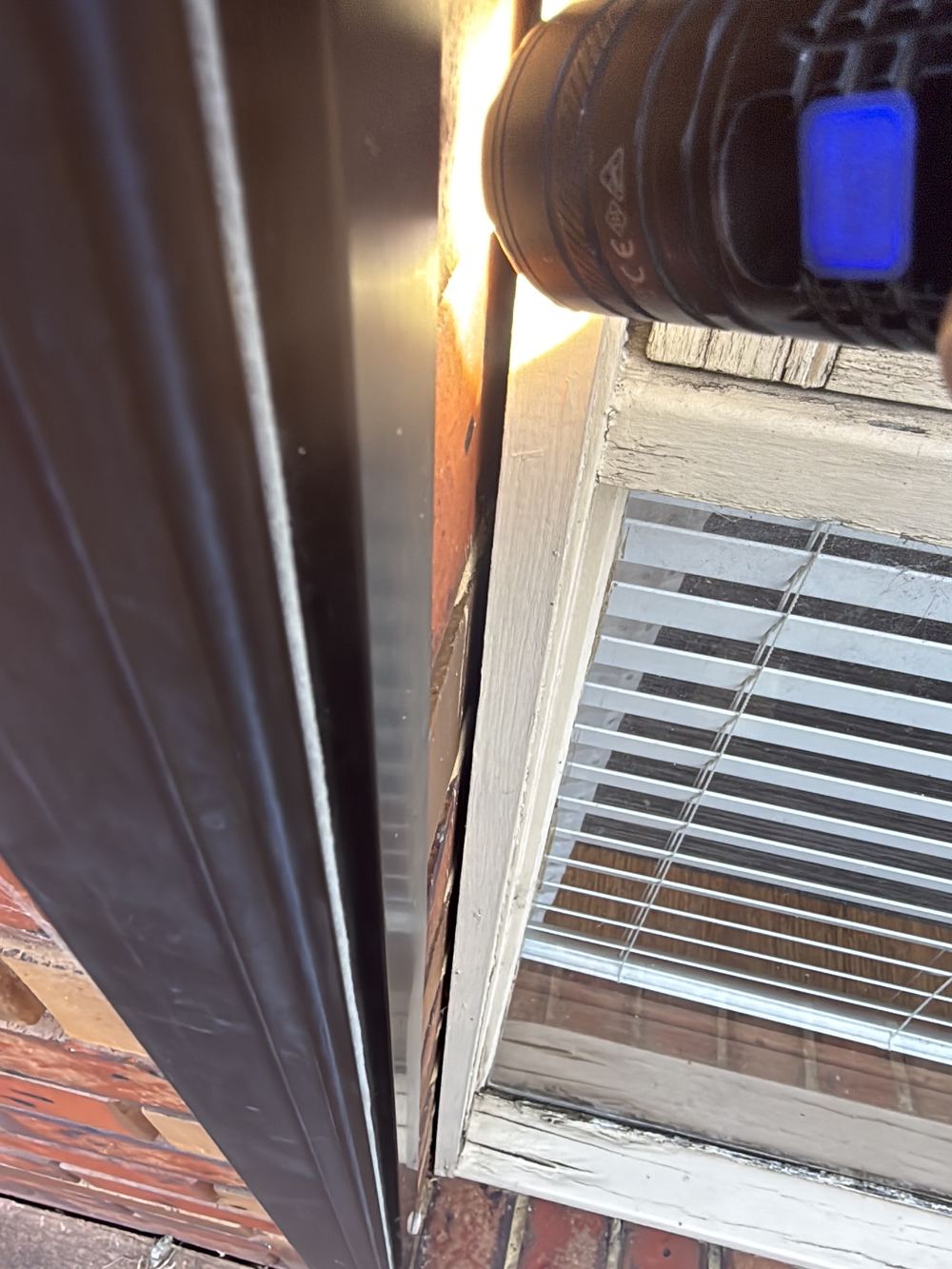 Gaps between window frames and brickwork open to wind driven rain, found during a defect investigation inspection in Aspendale Gardens