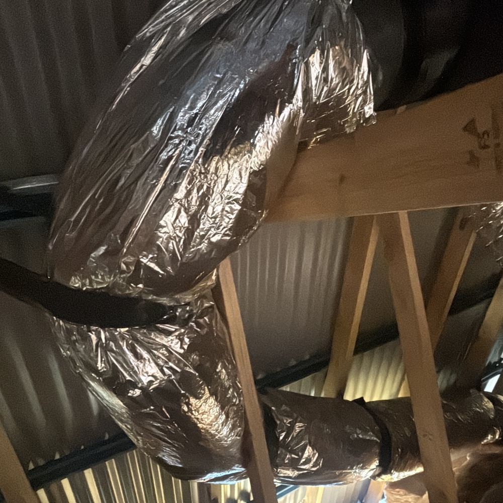 Heating duct crimped into tight bends, choking airflow to the rooms beyond, Clyde North