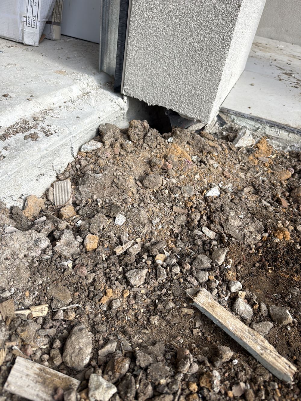 Garage wall bottom plate overhanging the slab well past what is allowed, found during a pre-handover inspection in Clyde North
