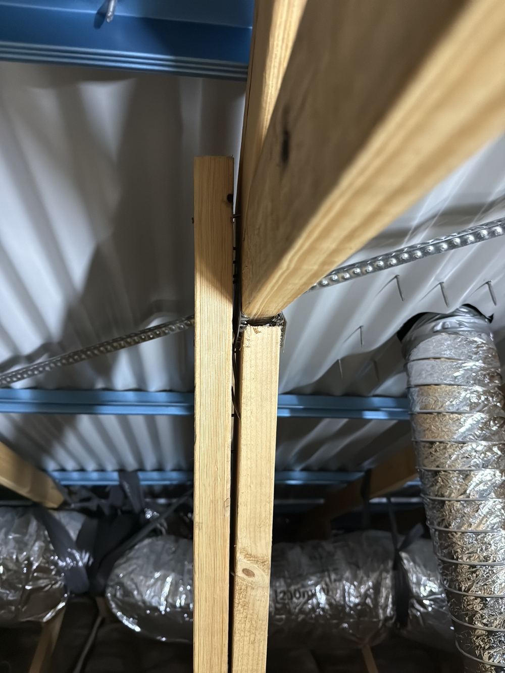 Damaged roof truss patched with a repair that does not match an approved detail, found during a pre-handover inspection in Clyde North