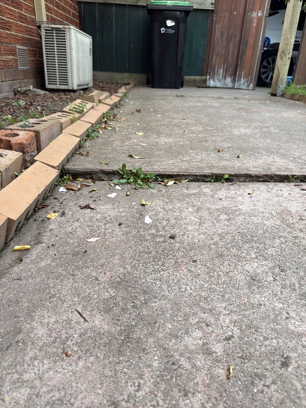 Concrete paths heaved up into trip hazards beside the house, Dandenong North, Clyde North