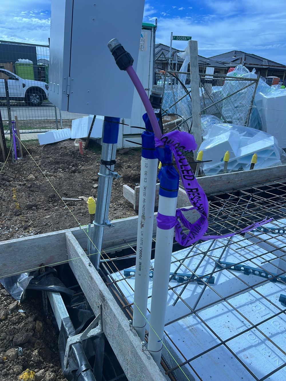 Termite collars fitted at the top of conduits instead of within the slab, found during a slab pre-pour inspection in Clyde North